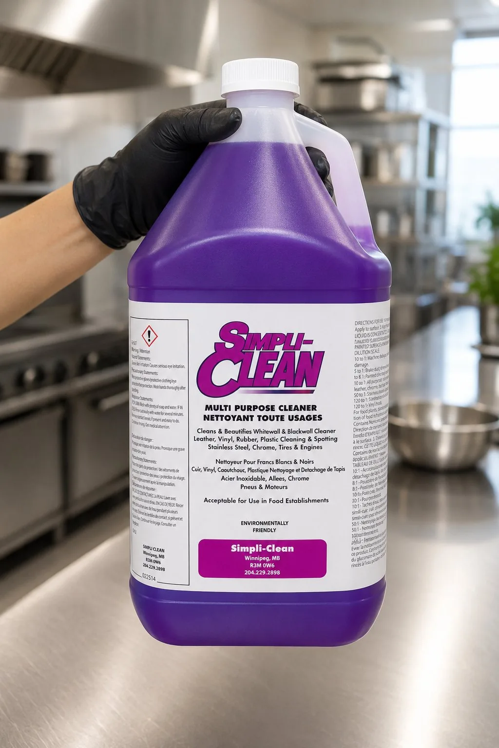 A gloved hand holding a 4-litre jug of SimpliClean in a commercial kitchen